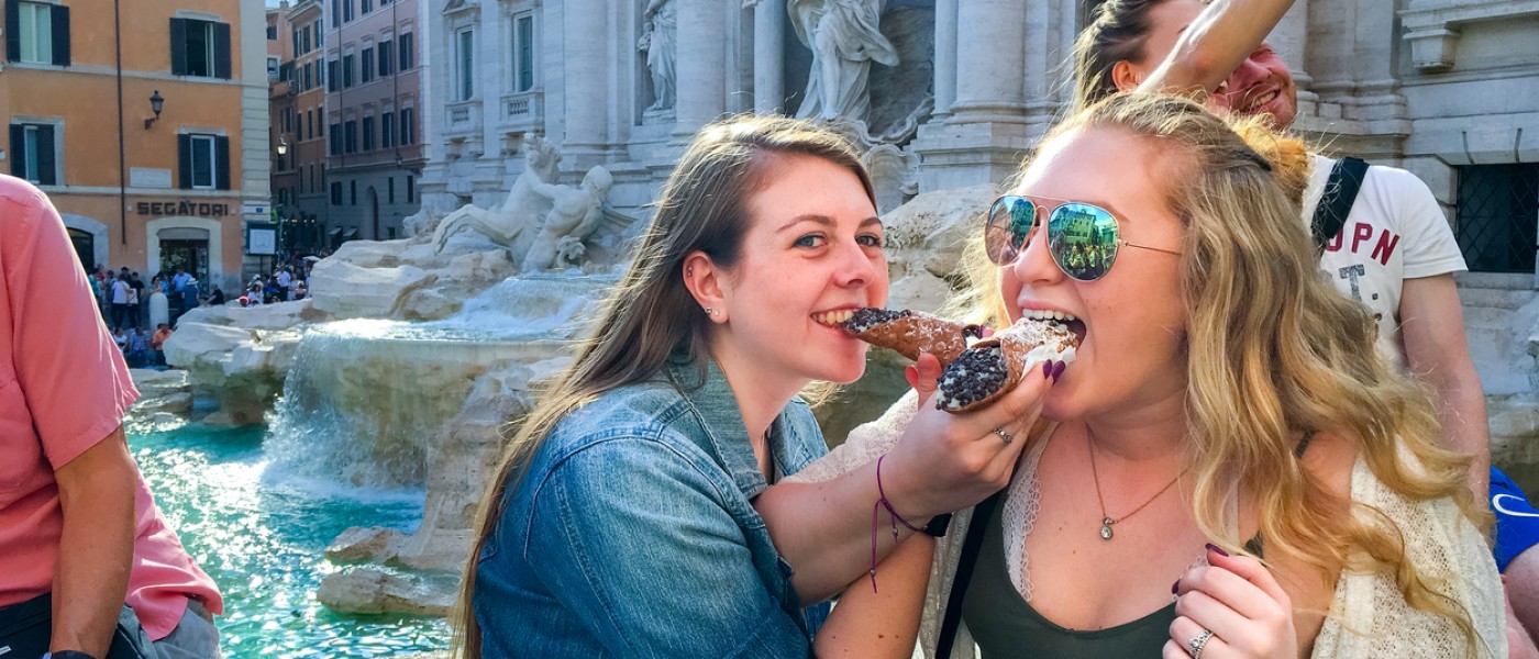 ֱ Students eating a cannoli in Italy